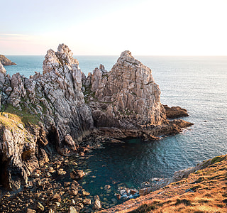 bird's-eye view of rock formation near ocean thumbnail