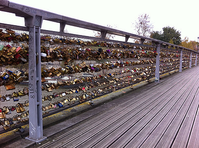assorted-color padlock lot on grey bridge thumbnail