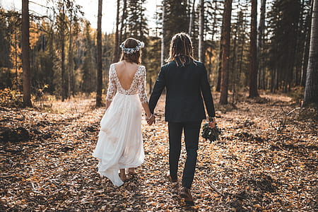 bride and groom walking surrounded by forest trees thumbnail