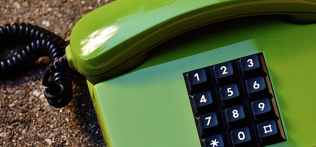 green and black corded home phone in close-up photography thumbnail