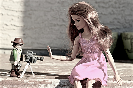 barbie doll in front of video camera with camera man during daytime thumbnail