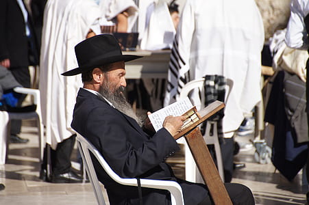 man sitting on chair and reading book thumbnail