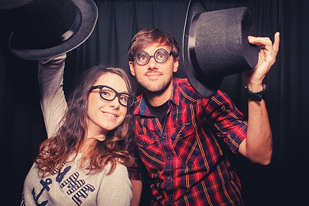 man and woman holding tap hat in front of black curtain thumbnail