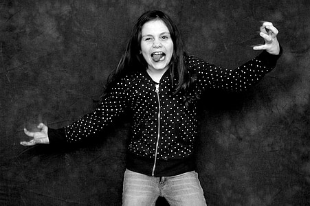 grayscale photo of woman doing tongue out thumbnail