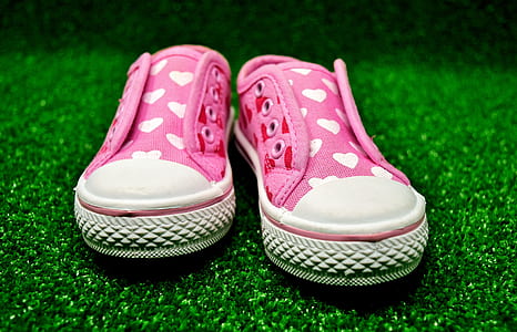 pair of pink-and-white heart print low-top shoes on green grass thumbnail