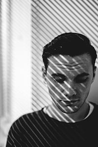 grayscale photography of man wearing shirt thumbnail