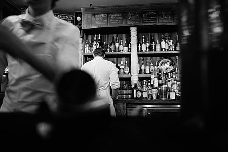 man in white coat in grayscale photography thumbnail