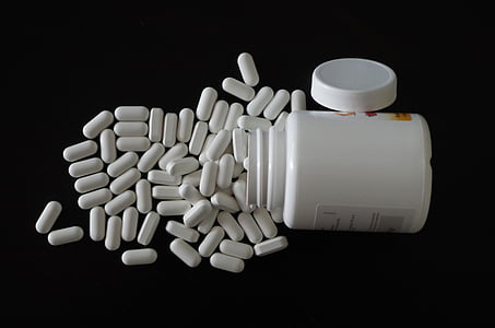medication capsules beside container thumbnail