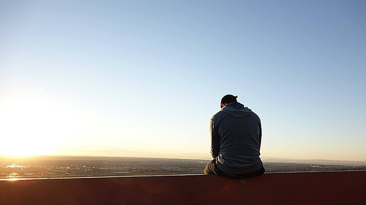 man sitting on rail thumbnail