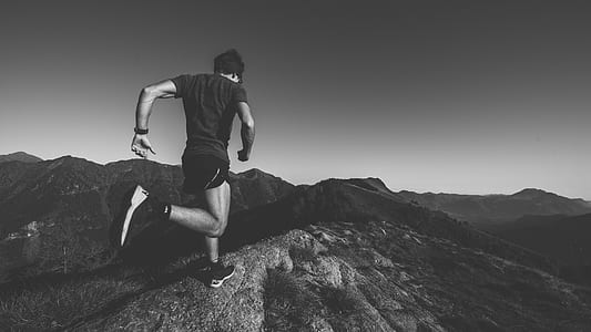 greyscale photography of man running on the field thumbnail