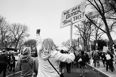 grayscale photo of people rallying in road thumbnail