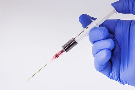 Doctor holding syringe thumbnail