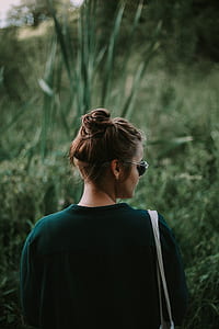woman standing near green plants selective focus photography thumbnail