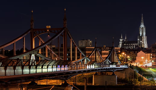 suspension bridge near buildings thumbnail