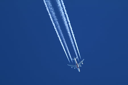 airplane with smoke under blue sky thumbnail