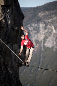 man balancing on black rope thumbnail