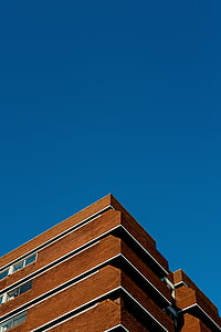 brown building under blue sky thumbnail