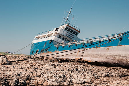abandoned white and blue ship thumbnail