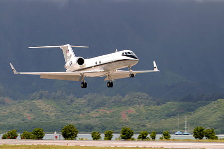 white monoplane flying near mountain thumbnail