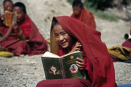 boy holding green covered book thumbnail