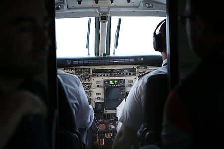 two men flying plane during daytime thumbnail