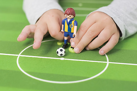 toddler holding soccer player figure thumbnail