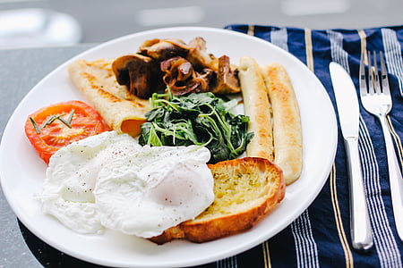 eggs, bread, and vegetable on white ceramic plate thumbnail