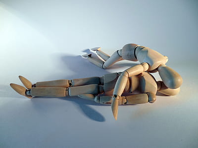 two brown wooden action figures thumbnail