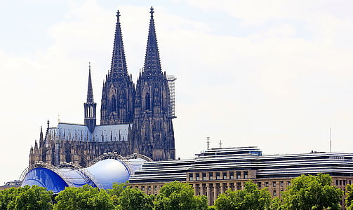 photo of brown cathedral under gray sky during daytime thumbnail