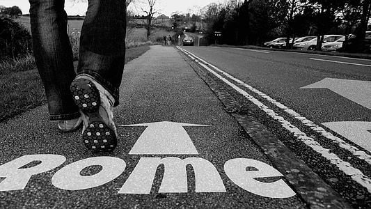 photo of person walking on a road with Rome signage thumbnail