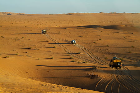 three off-road cars on desert sand thumbnail