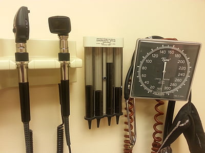 black blood pressure system and tools hanged on white wall thumbnail