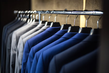 selective focus photography of suit jacket on hangers thumbnail