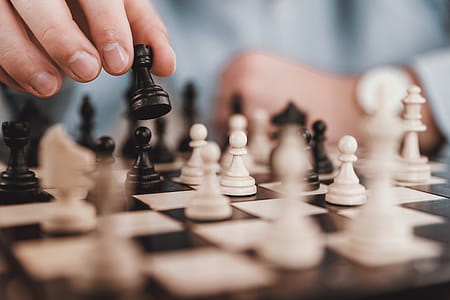 Young businessman playing chess in the office thumbnail
