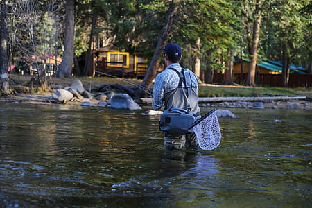 man fishing while on water during daytime thumbnail