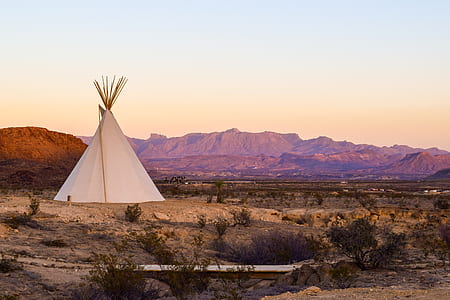 landscape photo of white tipi tent on a field thumbnail