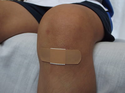 person wearing black shorts with band aid thumbnail