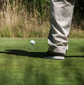 person standing in front golf ball on tee thumbnail