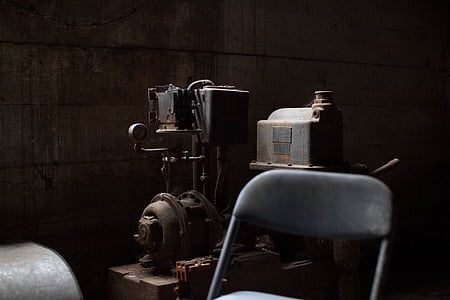 grey and black industrial machine near chair thumbnail