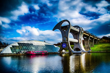 structures near body of water under cloudy sky thumbnail