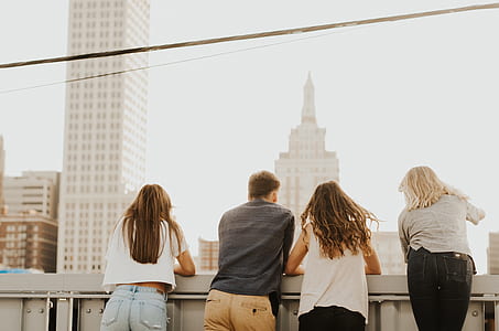 three woman and one man standing on terrace thumbnail