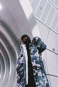 man standing inside silver concrete structure thumbnail