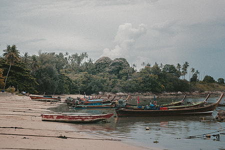 photo of boat park near seashore thumbnail