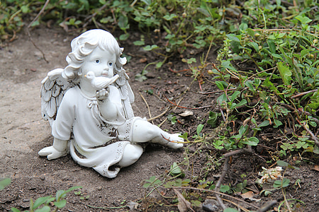 angel sculpture on gray concrete ground thumbnail