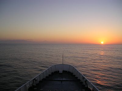 edge of white boat overseeing orange sunset thumbnail