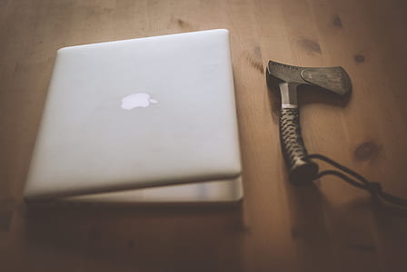 closed MacBook beside axe thumbnail
