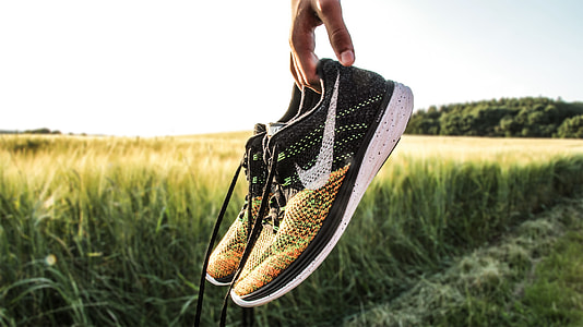 pair of black-yellow-and-white Nike sneakers thumbnail