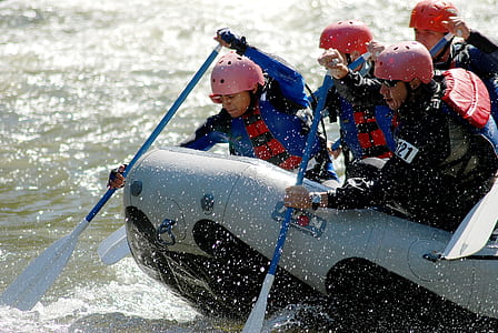 four person riding of raft boat during daytime thumbnail