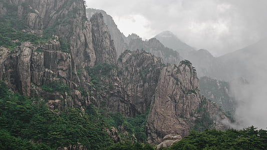 smoke on rock mountain with trees thumbnail