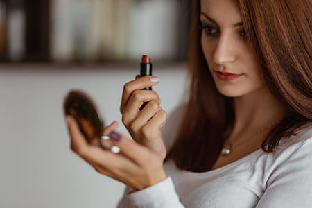 Young beautiful woman doing her make up thumbnail
